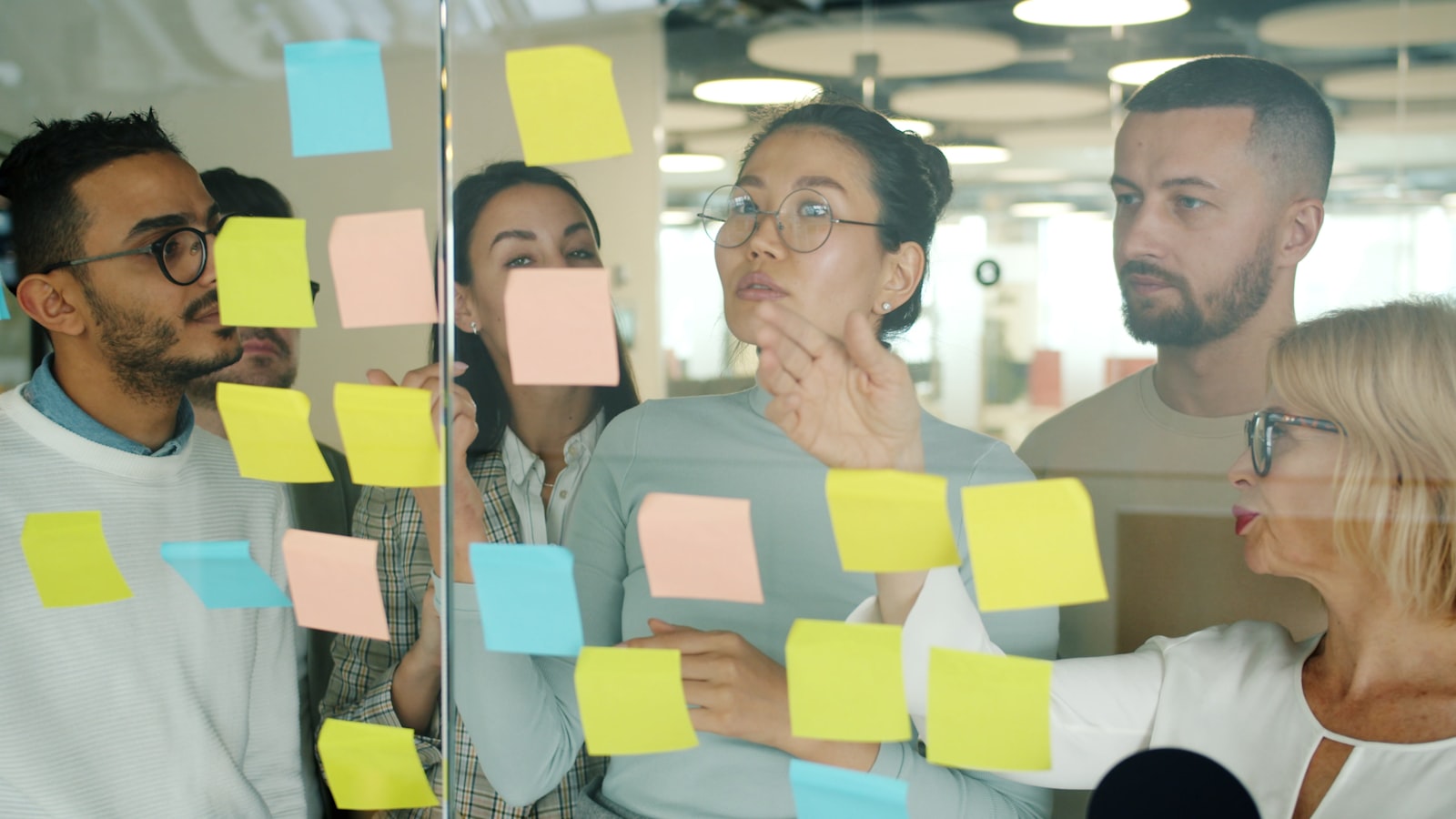 Diverse team collaborating on sticky notes. — photo by Vitaly Gariev on Unsplash