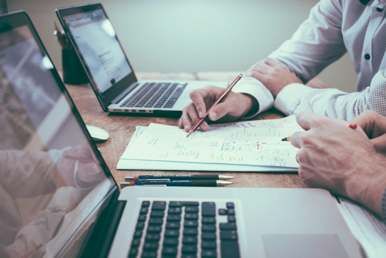 Person holding pencil near laptop computer — photo by Scott Graham on Unsplash