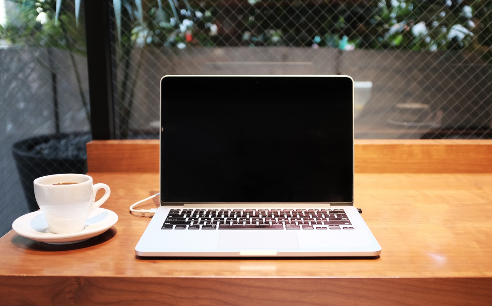 Laptop computer beside coffee mug — photo by Alex Knight on Unsplash