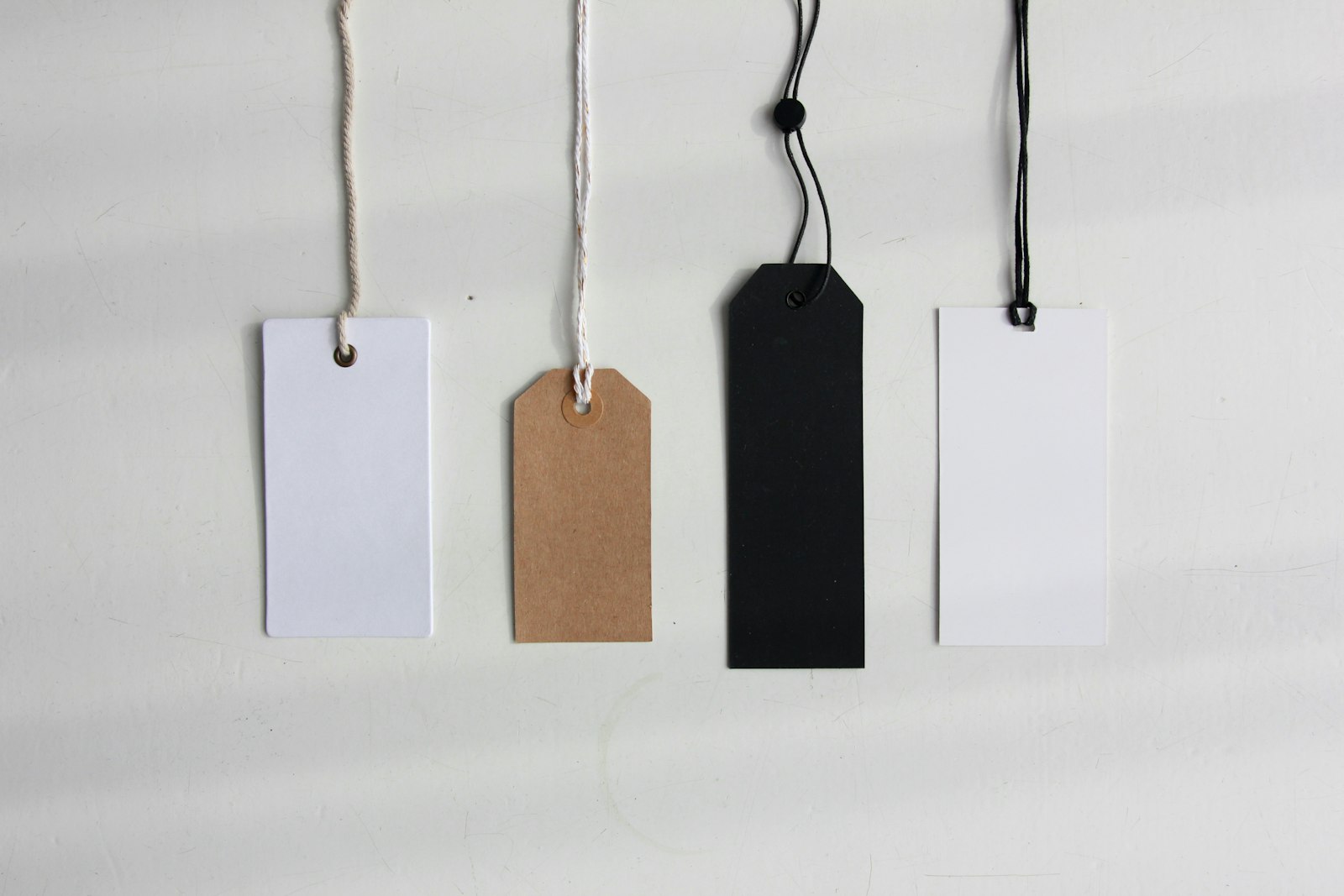 Four paper card tags — photo by Angèle Kamp on Unsplash