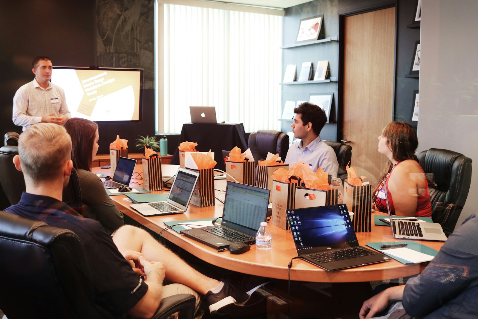 Man standing in front of people sitting beside table with laptop computers — photo by Campaign Creators on Unsplash